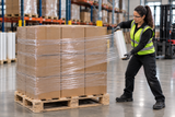 Clear hand stretch wrap applied around stacked cartons on a wooden pallet