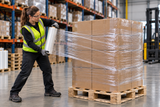 Clear hand stretch wrap securing a palletized carton load in a warehouse