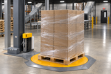 Machine stretch wrap securing a tall palletized load on a turntable wrapper