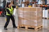 Clear hand stretch wrap being applied to a palletized warehouse load