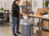 Garbage Bags - 35" x 50" - Clear - Strong - 40-45 gal - 125/Case fitted open in an opaque commercial waste bin in a packing room