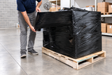 Black hand stretch wrap concealing and securing a palletized load